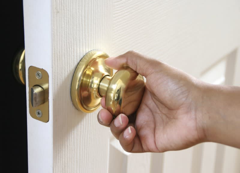 OCD person holds door handle