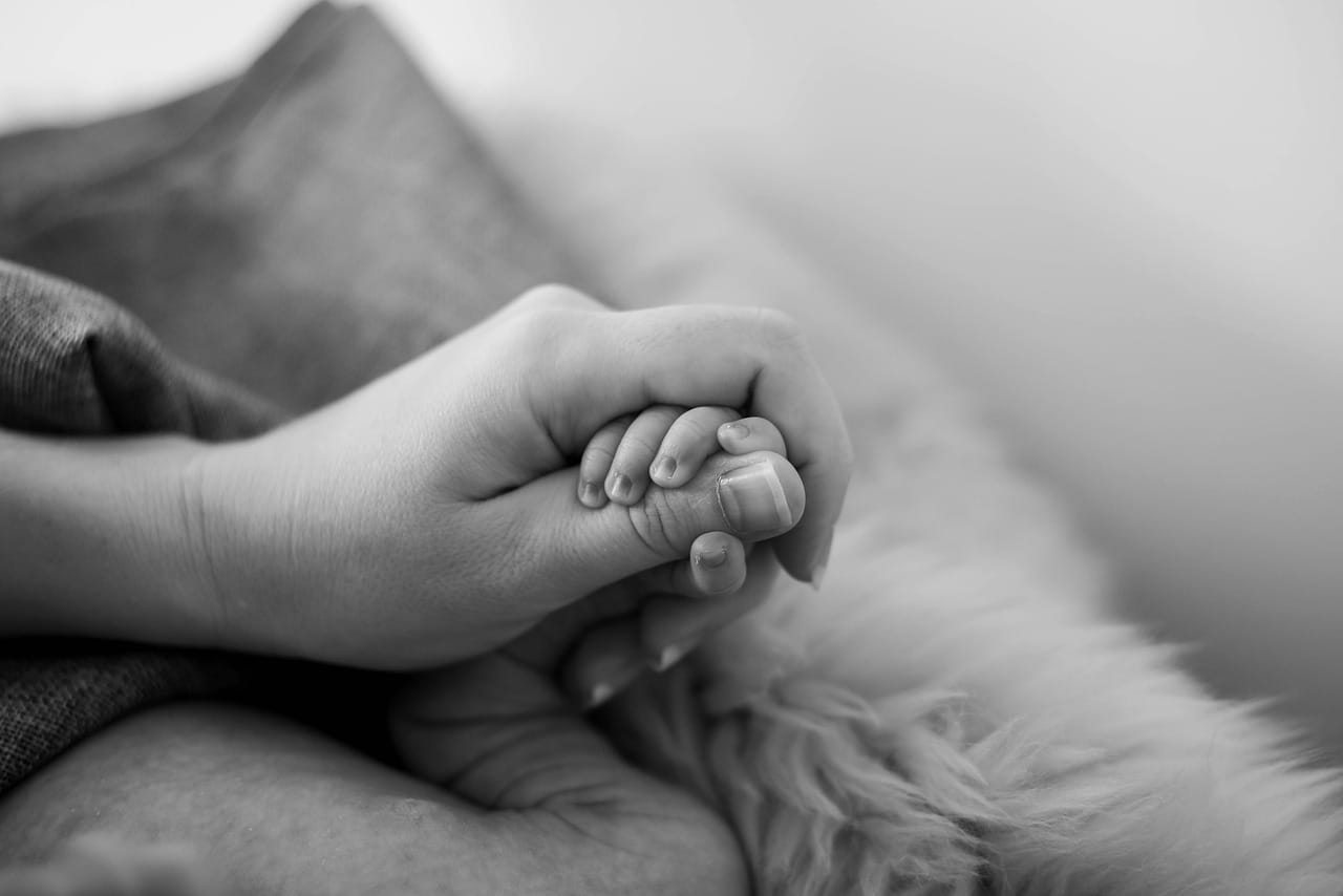 Babies holding mothers